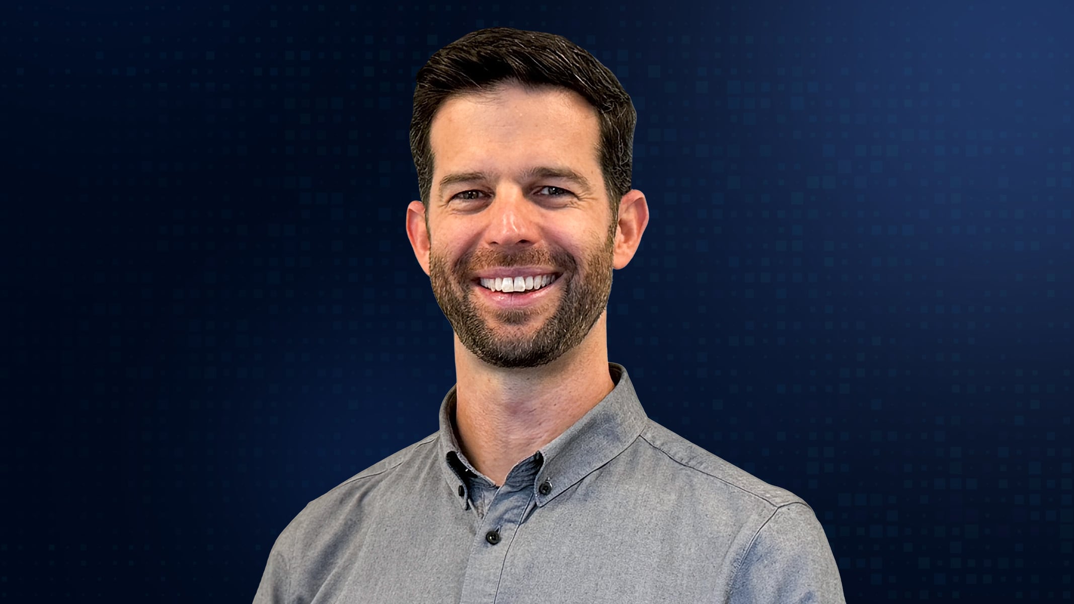 Portrait of Jim Moore smiling in a gray collared shirt