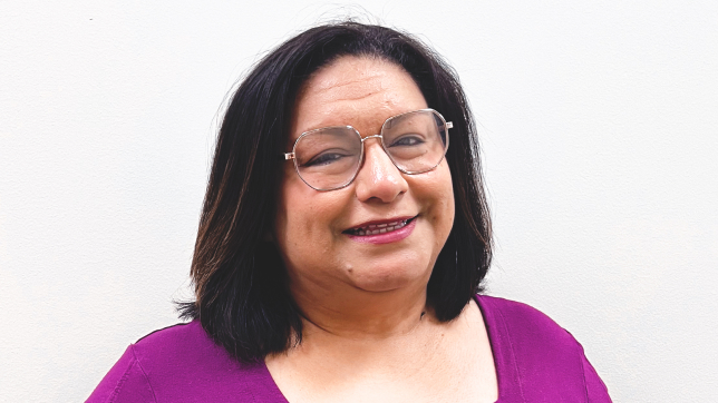 A picture of Brenda Garza wearing glasses and a purple blouse