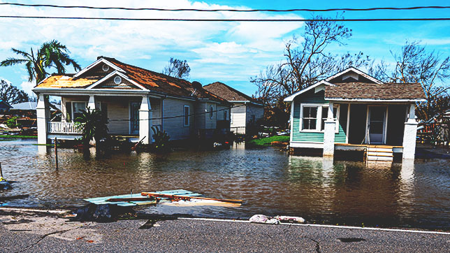 Two destroyed homes on a flooded street in Louisiana