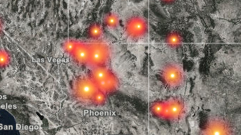 A grayscale map of Southern California, Arizona, and Nevada with wildfire locations marked in orange
