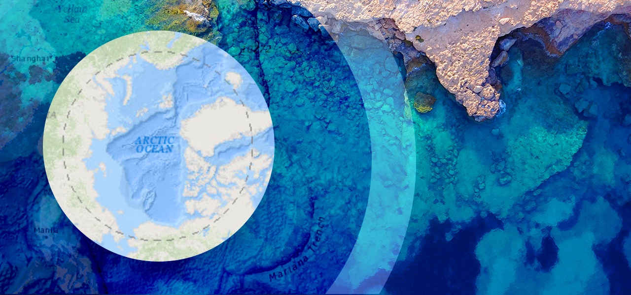 An birds-eye image of the clear blue water over the Mariana Trench overlaid with concentric circles containing maps of the land beneath