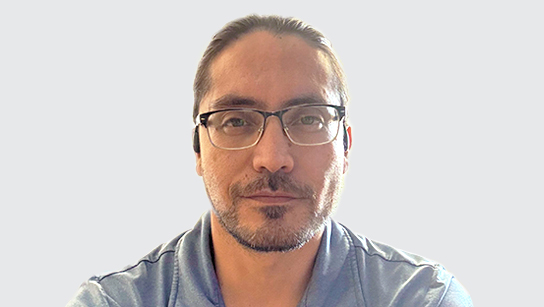 Portrait of Enrique Villarreal in a light blue collared shirt