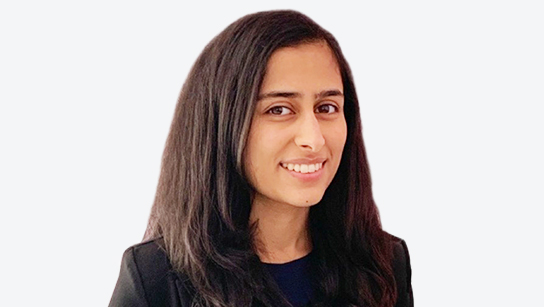 Prisha Puri smiling in front of a white background