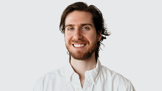 Portrait of Sean Allen smiling in a white collared shirt