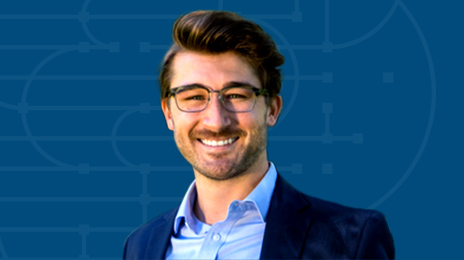 Zak Etem smiling and wearing business attire overlaid on a blue background with graphic elements