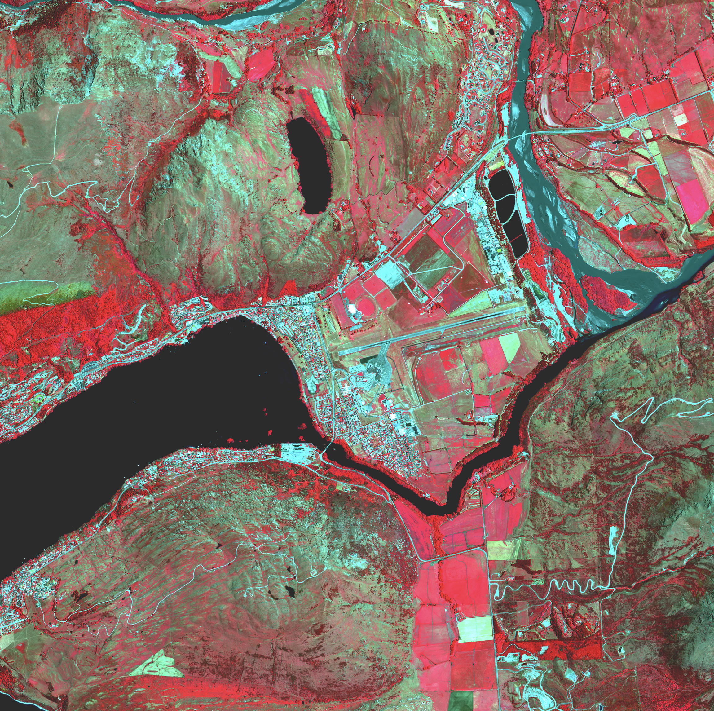 A map of a town next to a river shows hot spots and farm fields in shades of red