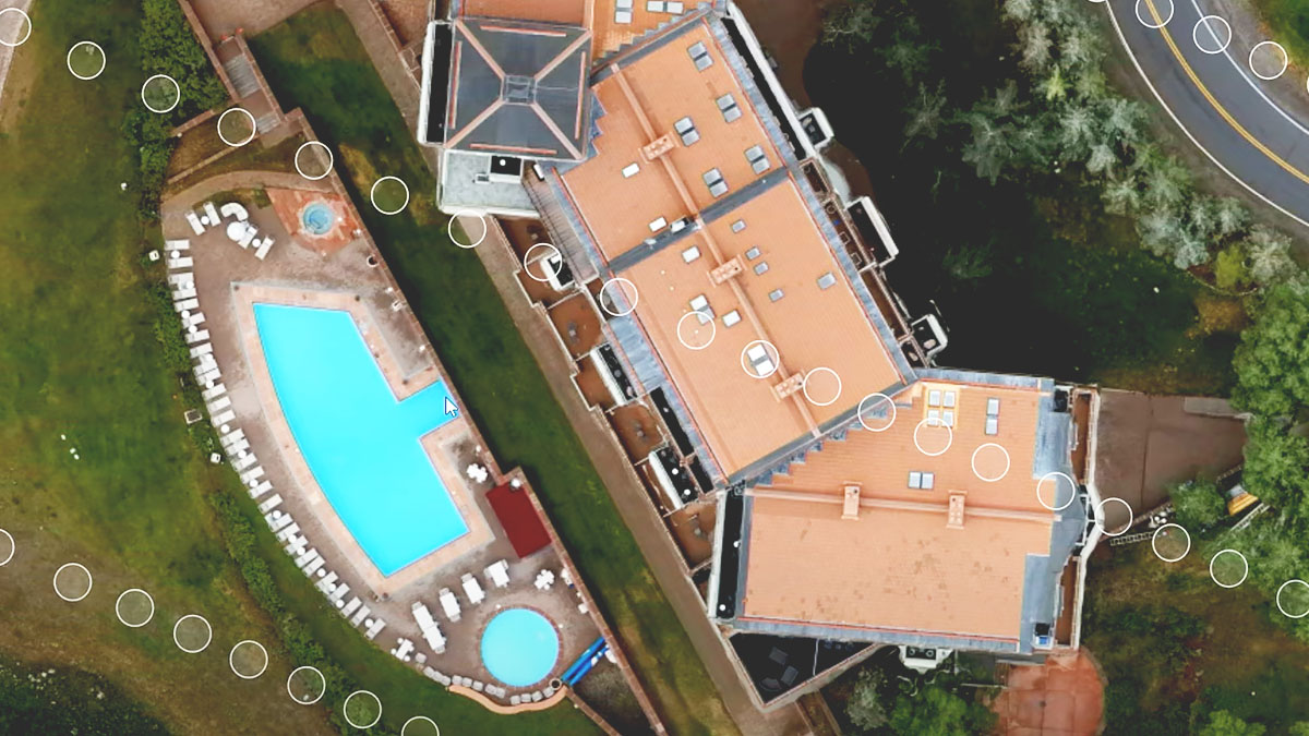 A nadir image of a multi-unit building with a swimming pool