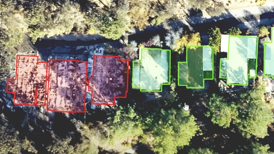 Drone imagery shows structures along a road, with undamaged buildings identified in green and damaged ones in red