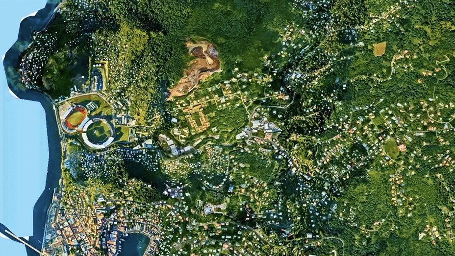 Satellite imagery shows a forested waterfront region with a densely populated area along the coast