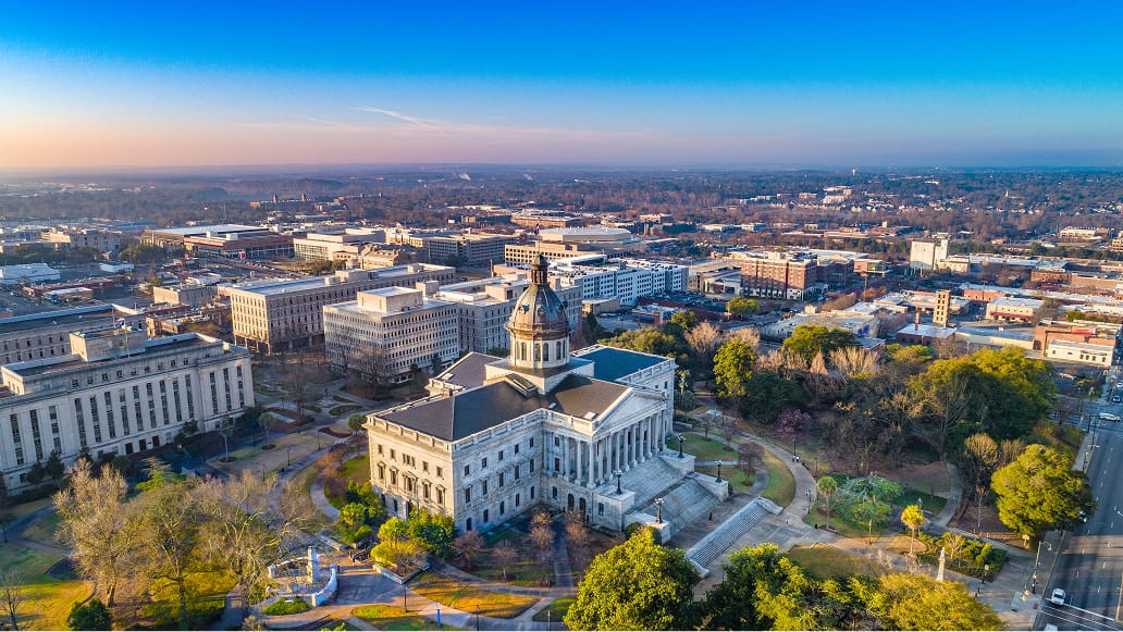 A bird’s eye view of a historic government building on a clear, sunny day