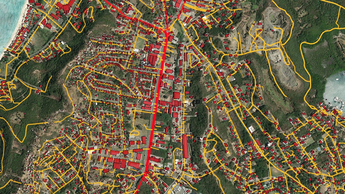 A feature extraction workflow applied to a satellite image of Grenada shows roads in red and yellow and buildings in red