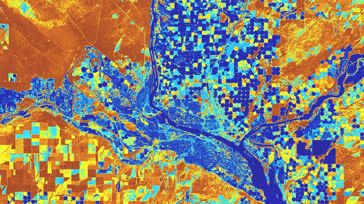 A satellite image shows plots of land along a river with square and circular fields highlighted in blue, orange, and yellow