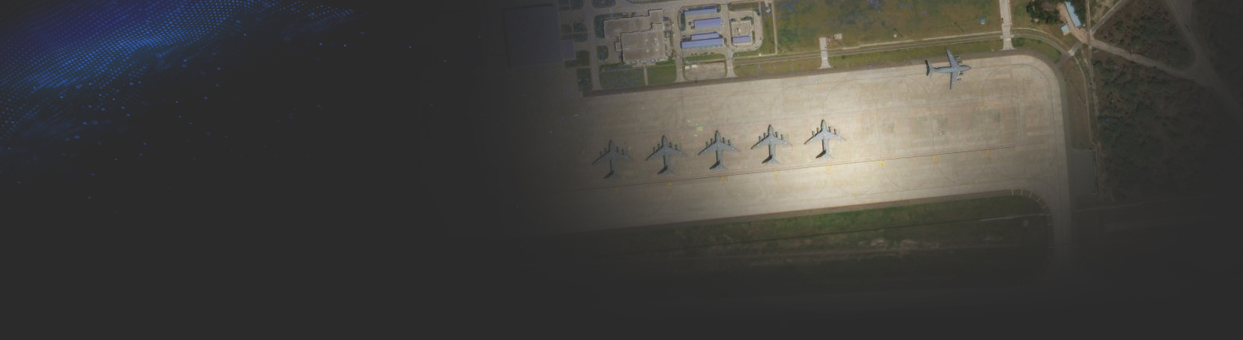 Image of a military airfield with jets parked on the tarmac.