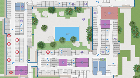 Vue aérienne numérique d’un bâtiment avec des carrés, des arbres verts et de l’eau bleue représentant une interface de gestion des données indoor.