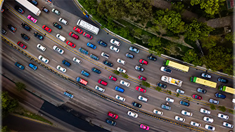 An aerial view of a freeway with many cars in all lanes