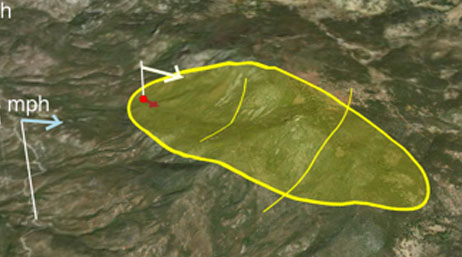 Satellite image of hilly terrain with yellow circle