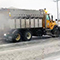 A snow plow removing snow from a road