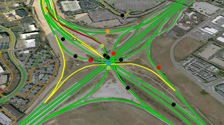 An aerial view of a freeway interchange overlaid with routes traced in green and yellow