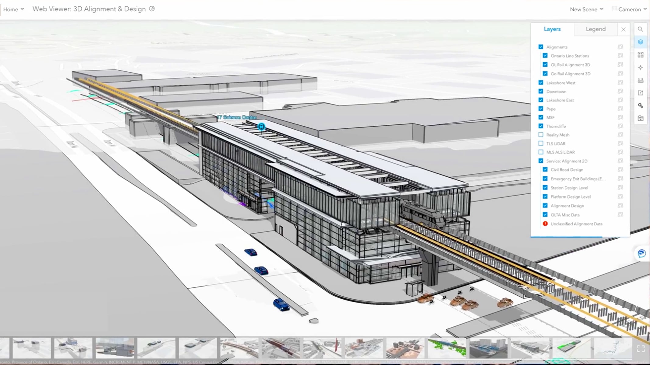 A 3D model of a large building with integrated rail tracks and surrounding infrastructure