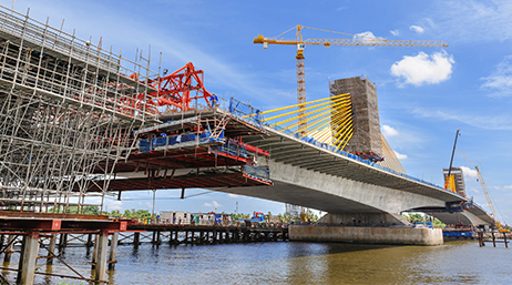 An overwater bridge under construction by architecture, engineering, and construction (AEC) project teams