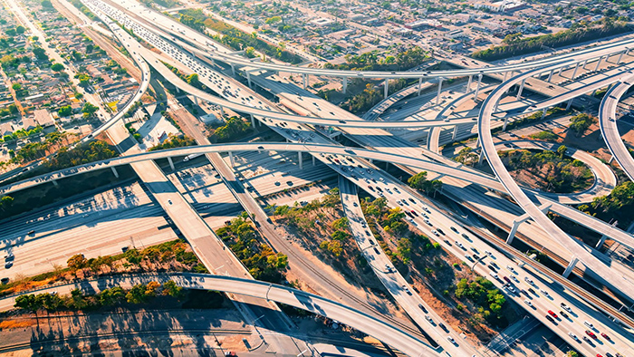 An aerial photo of a complex highway interchange with several layers of swooping overpasses leading in different directions