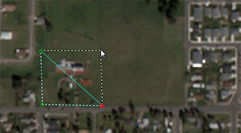 A satellite image of a field surrounded by homes to show how to redact a parcel