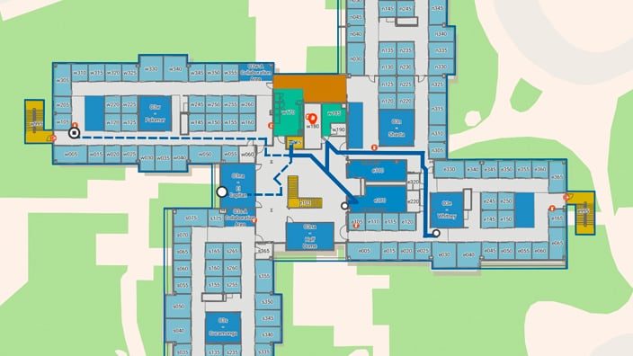 2D map of a building showing color-coded offices, common areas, stairs, and conference rooms.