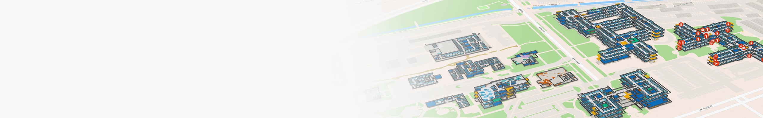 Carte numérique 3D d’un vaste campus, affichant des plans d’étage en intérieur avec code couleur de plusieurs bâtiments dans lesquels des icônes représentent les équipements d’urgence