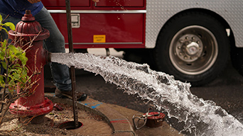 Red fire hydrant with water shooting out