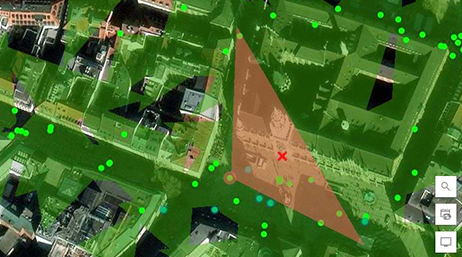 An aerial image of the rooftops of a city neighborhood overlaid with map points and shaded areas in green and orange