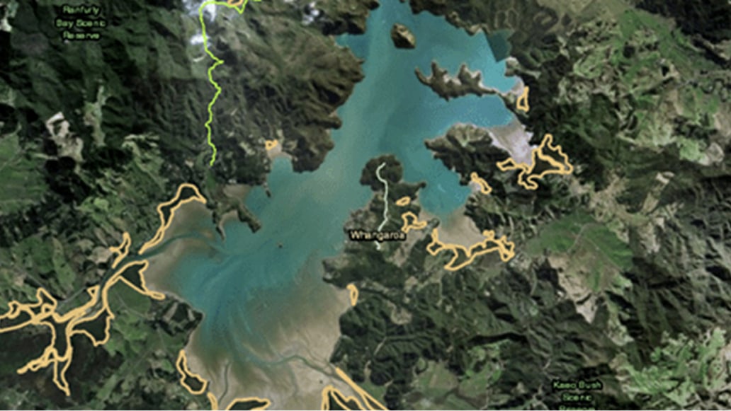 A satellite image of a reservoir and surrounding green terrain