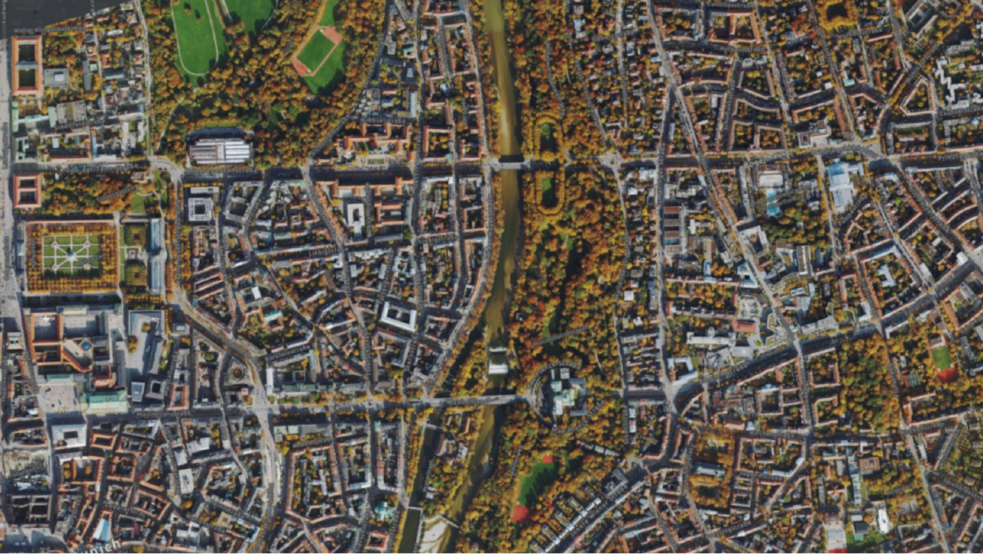 An aerial view orthomosaic image of a city with buildings, vegetation, and roads