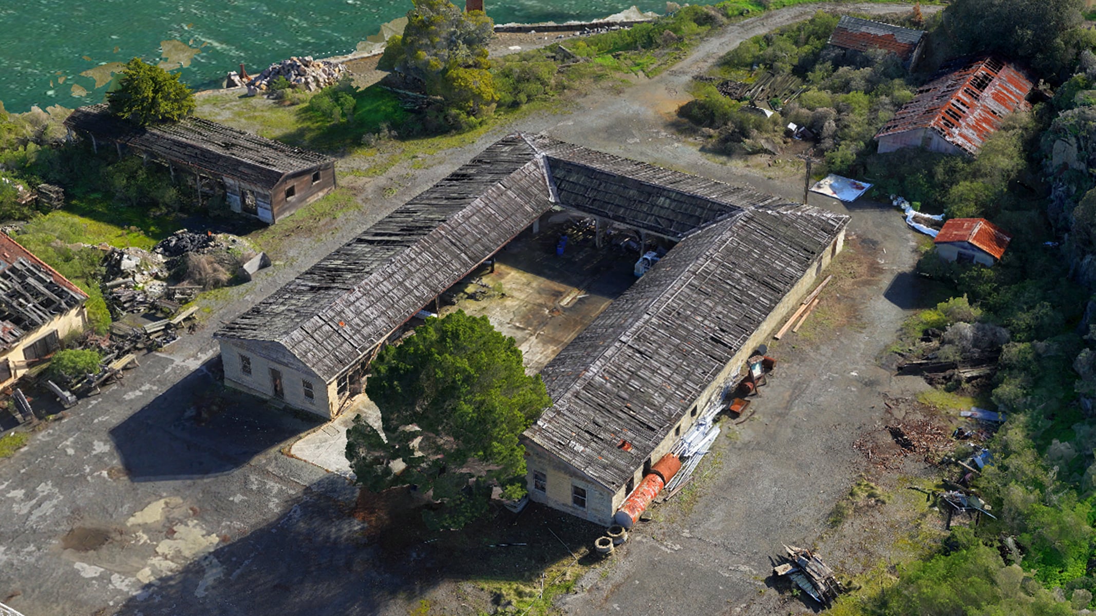 An aerial view of a u-shaped building surrounded by foliage