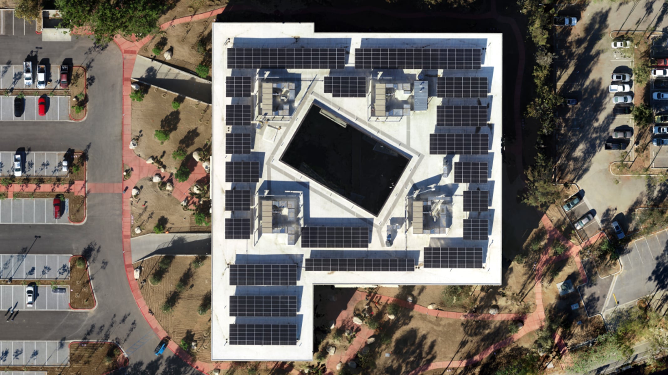 An aerial view of a building near a parking lot on the Esri campus