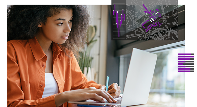 Young woman with orange top working on a laptop computer with a small image of a street map