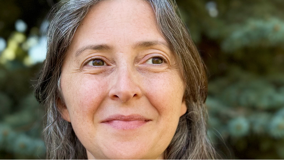 Stephanie Smith smiling in front of green foliage in soft focus