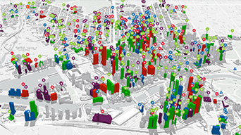 A white city map with bright green, red, and blue 3D bars resembling city buildings scattered across it