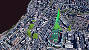 An aerial view of a city and roads with a few green 3D buildings added