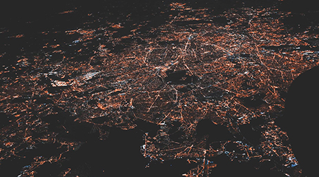 An aerial view of a region brightly lit at night