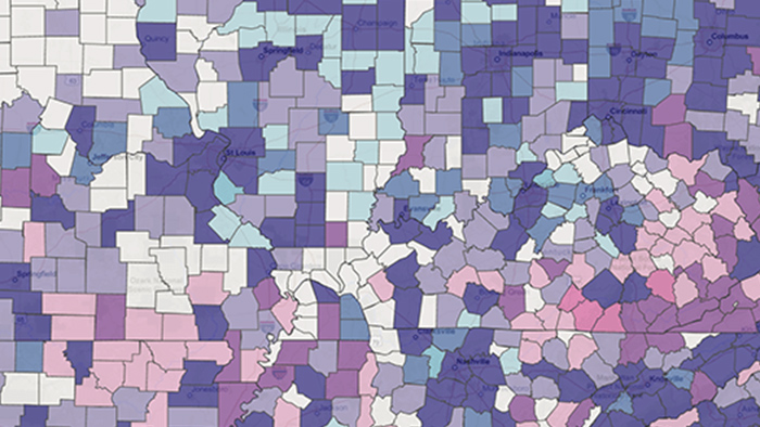 Gráficos azul-esverdeados em um fundo amarelo com texto que diz: "Esri Partner Conference, 15 a 17 de março de 2021"