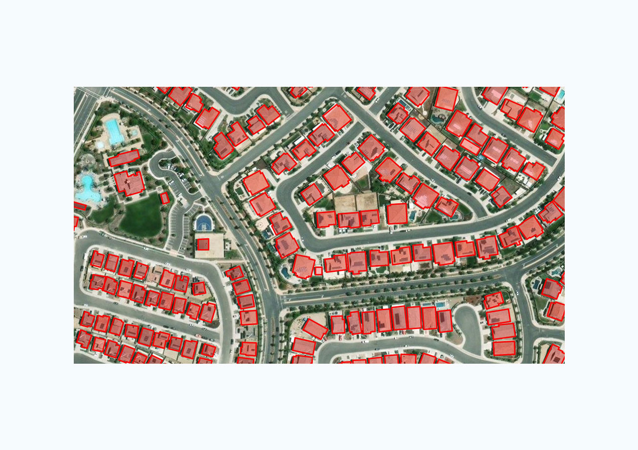  An aerial view a residential area with homes outlined in red, depicting the application of pretrained models