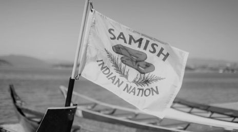 A Samish Indian Nation flag mounted on the back of a boat
