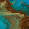 A satellite view of Earth showing a turquoise ocean and brown land masses
