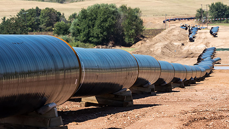 Long silver pipeline in a field
