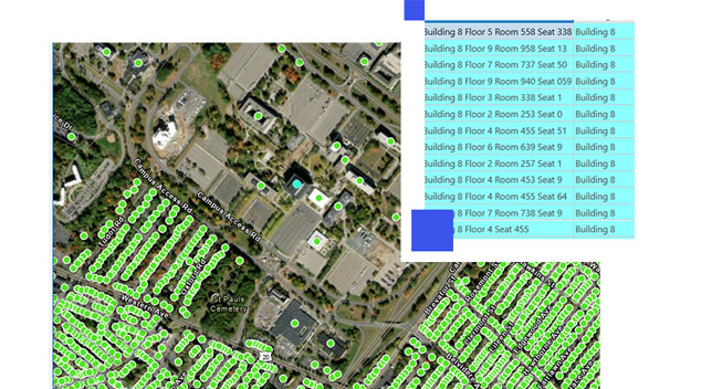 Aerial image of an office complex with green data points and building data