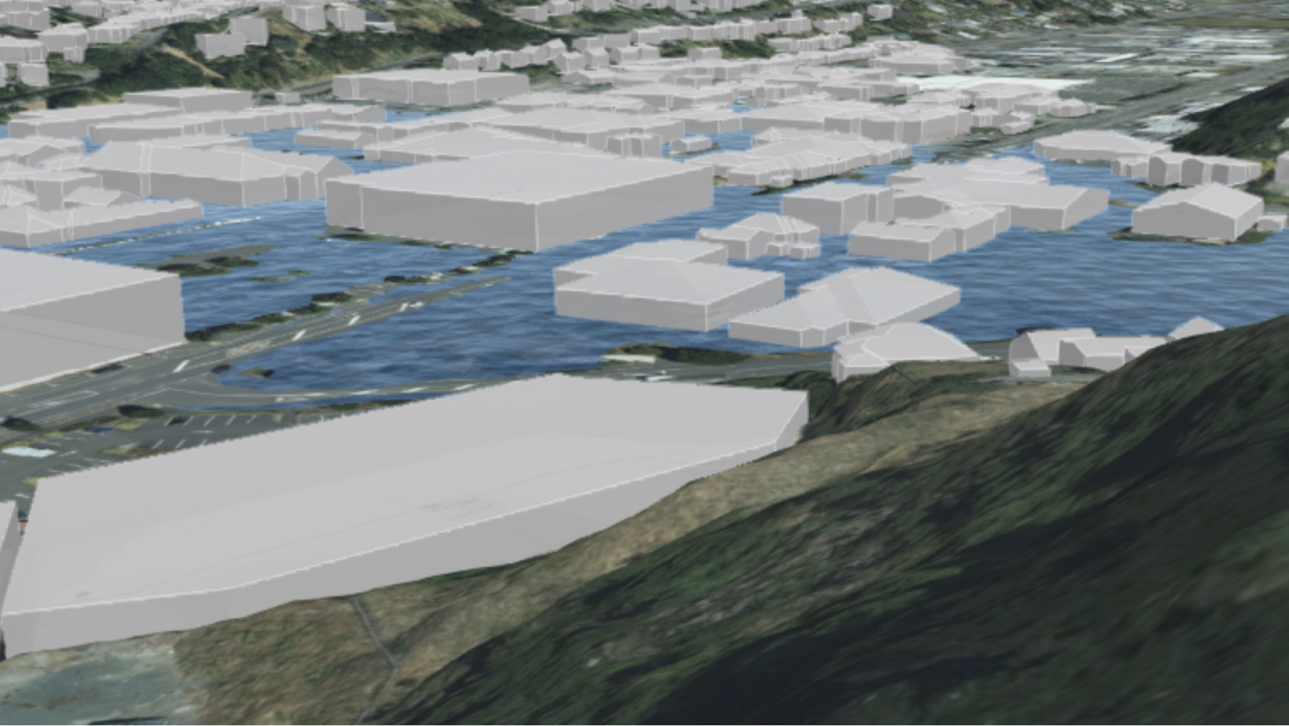 洪水の危険性の影響を受ける建物を示す青の水域と白の氷のブロックを表示した 3D マップ