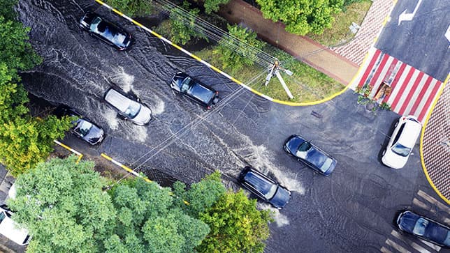 Aerial view of cars driving on a flooded road