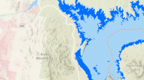 A contour map of a mountain region in pale grays with a large lake shown in blue