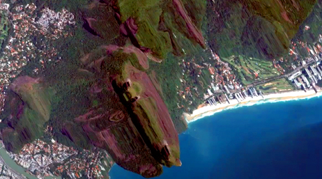 A screencap from the featured video showing a 3D model of a vibrant green coastal area with towering mountains and deep blue oceans
