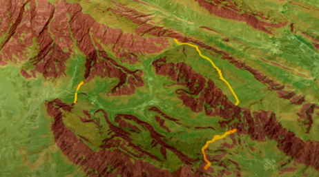A screencap from the featured video showing a contour map of a green and brown mountain region with routes shown in yellow